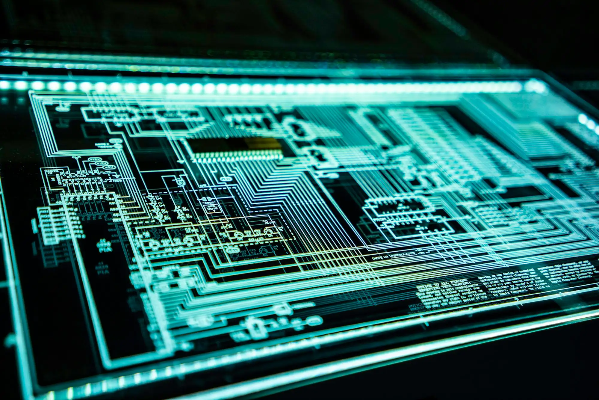 Glowing circuit paths on a dark circuit board