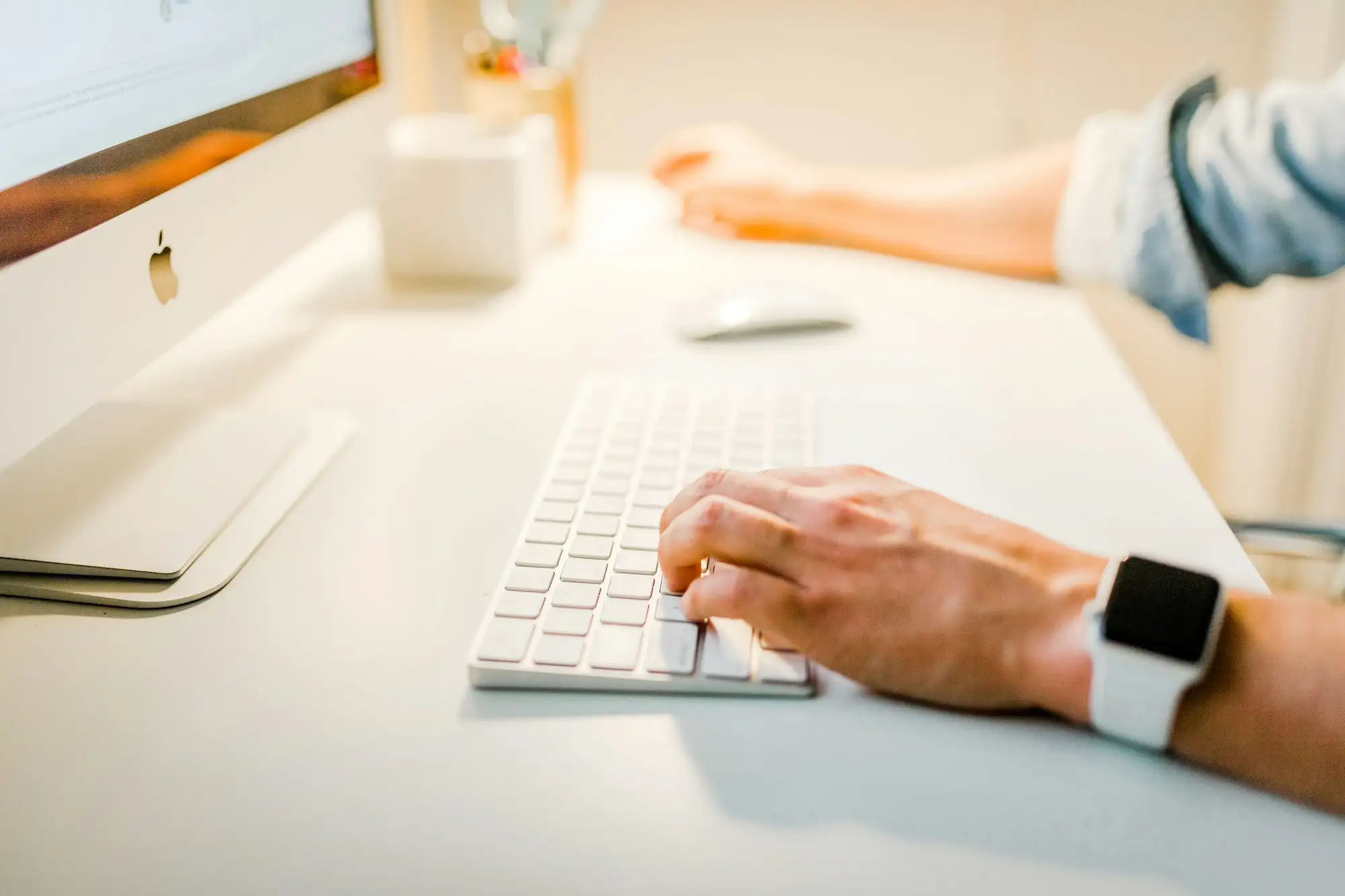 Hands on a light keyboard and mouse
