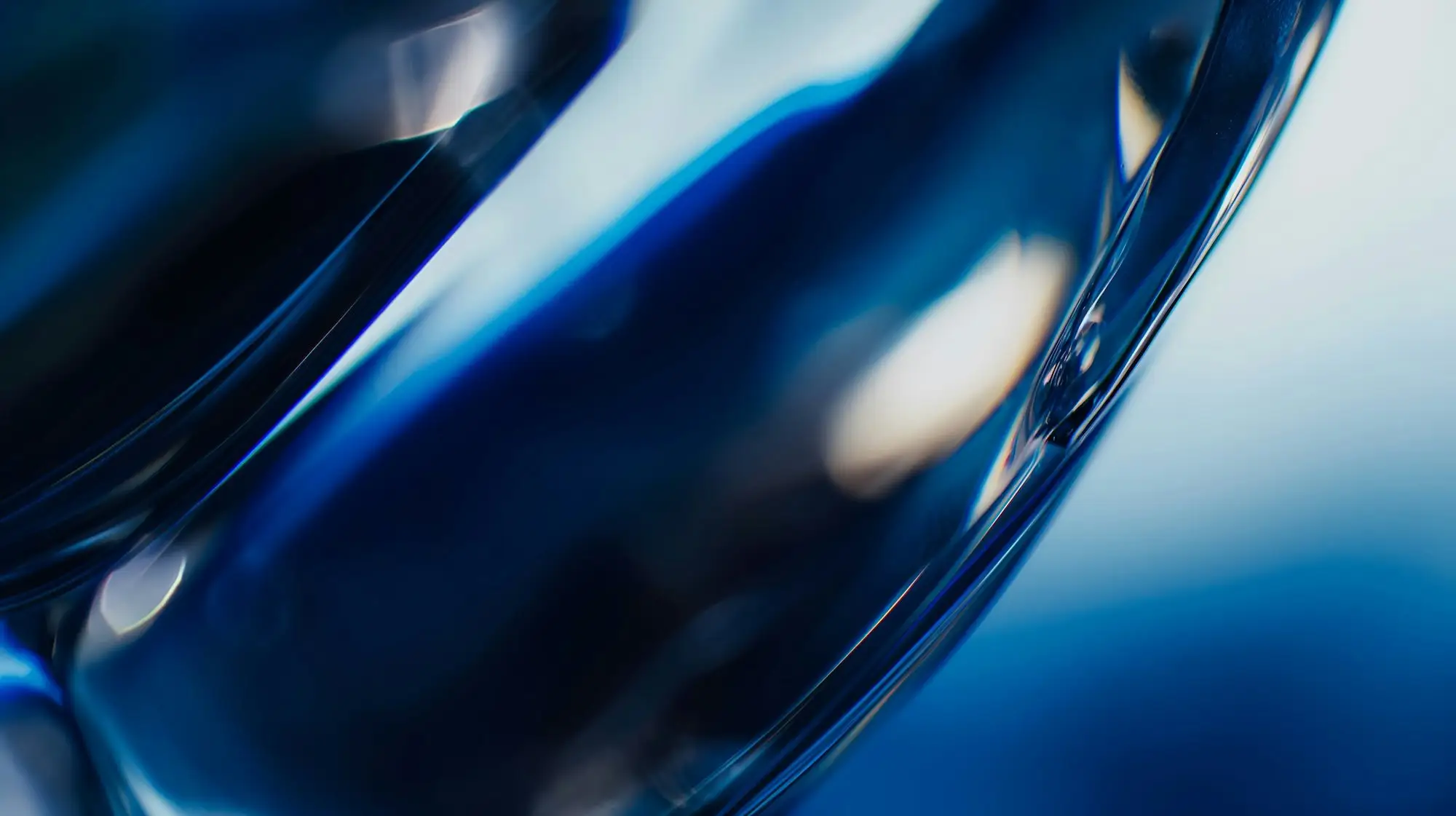 Blue glass object with soft light reflections